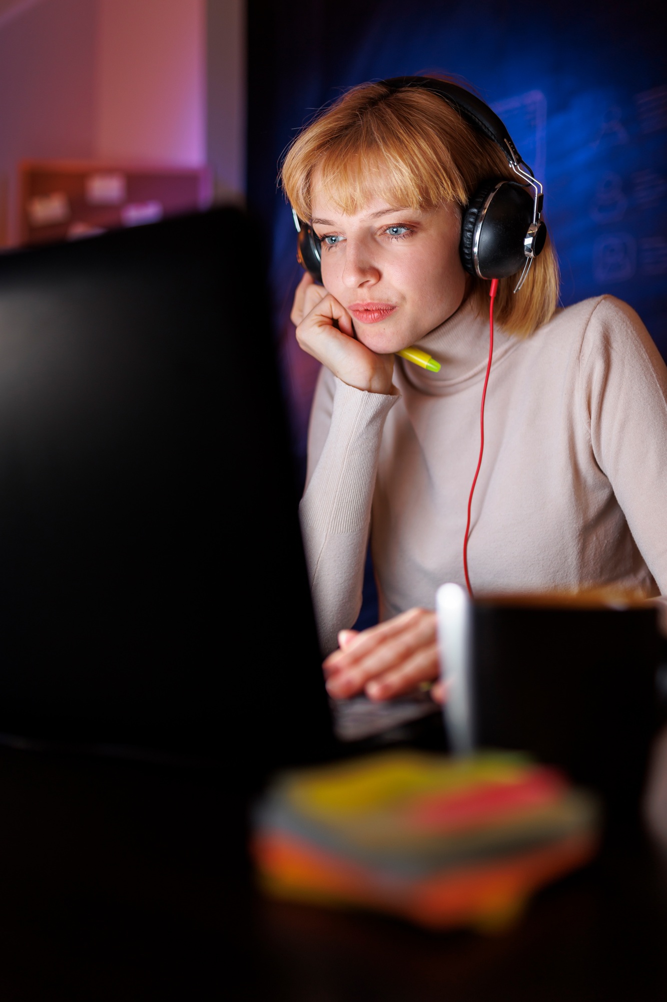 Female web developer working late in an office